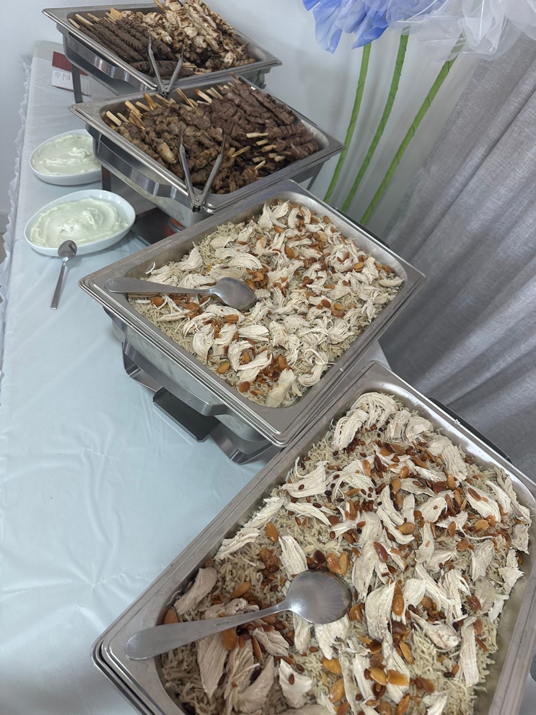 Chafing dishes with skewers and chicken rice ready to serve